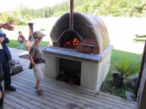 A fired-up pizza oven on show during the Permaculture Home and Garden Tour